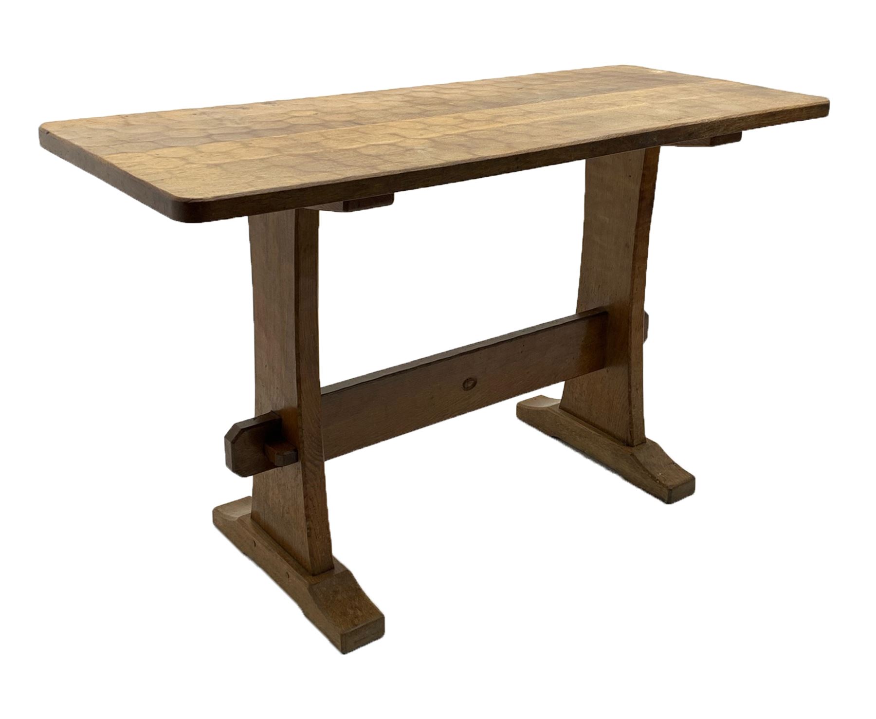 'Acornman' oak table with rectangular adzed top, shaped end supports on sledge feet joined by pegged stretcher carved with acorn signature, by Alan Grainger of Brandsby, York