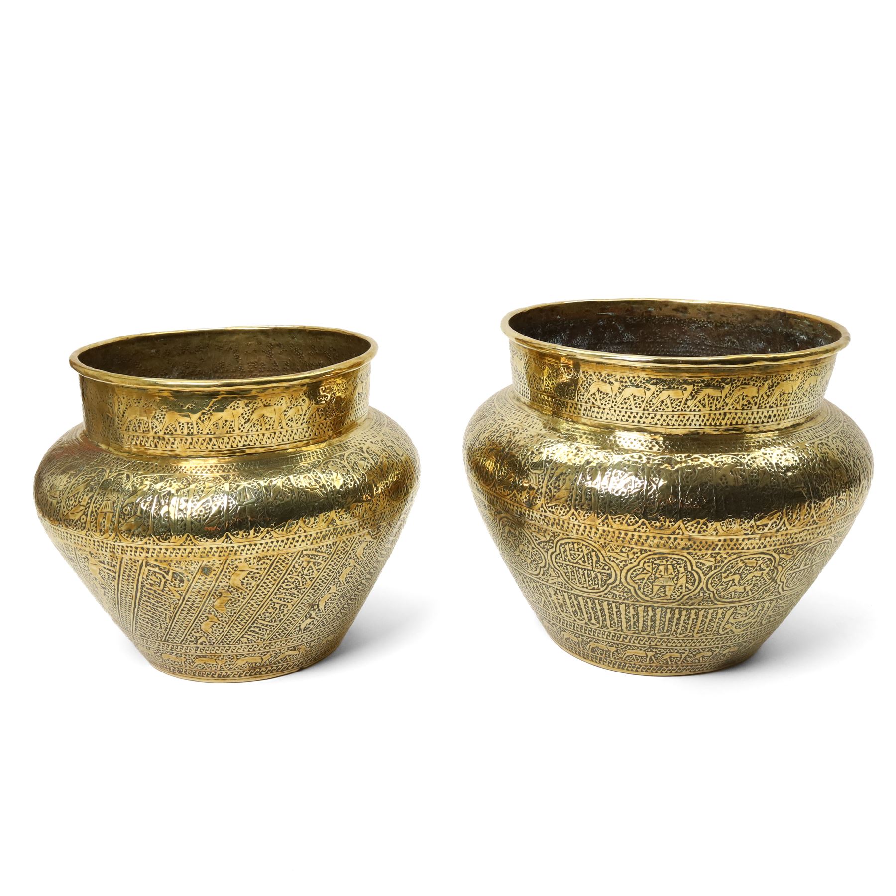  Islamic brass jardiniere  with all over engraving of figures, animals etc D31cm and a slightly smaller matching jardiliere D27cm 