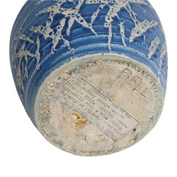 Quentin Bell 1910-1996: ribbed vase with fluted rim, decorated in white abstract design on a blue ground, signed Bell beneath, H16cm 