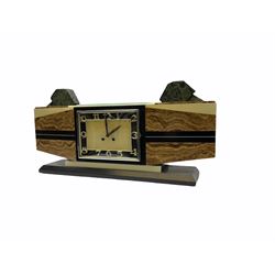 1930’s French Art Deco mantle clock in distinctive vein cut brown marble with inlaid cream and black marble, rectangular dial in contrasting black and cream marble with distinct offset chrome Arabic numerals, baton hands and chrome bezel, two train eight-day Parisian countwheel movement striking the hours and half-hours on a bell, Swiss in-line lever platform escapement, steel balance with timing screws,
the rectangular case raised on a black and cream marble plinth with additions of oblique green granite to the top.   
movement stamped “Marti & Co” 