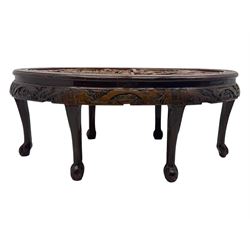 Early 20th century Chinese hardwood nesting coffee table, oval top carved with figures and traditional pagoda scenes with carved frieze, complete with six inset stools or side tables, raised on tapering supports with paw feet