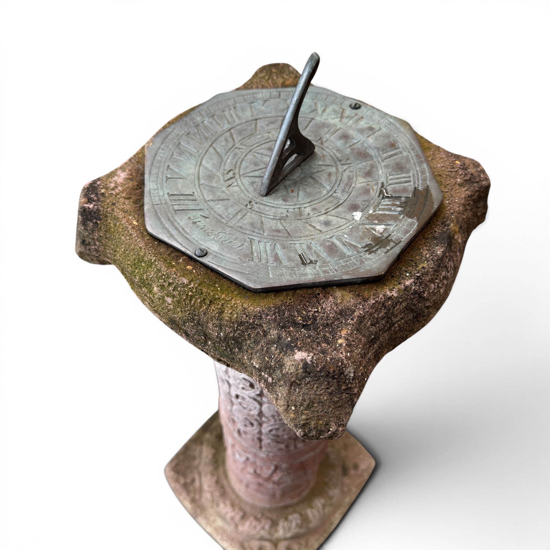 Weathered cast stone sundial, shaped top with metal dial, patterned column