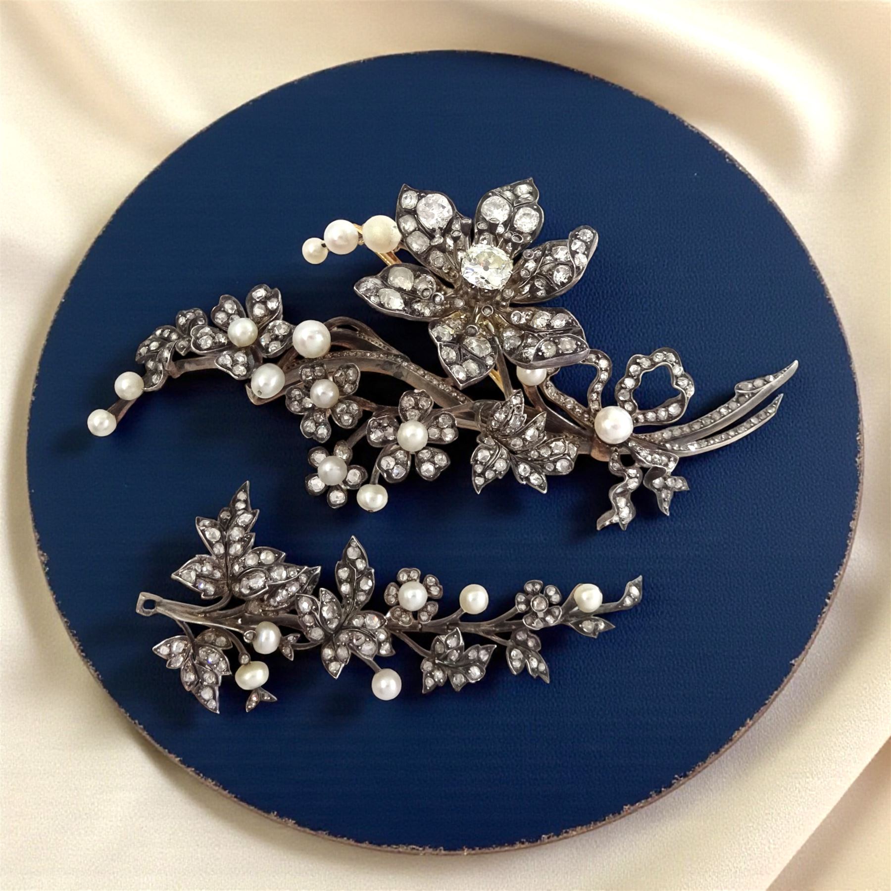 19th century gold and silver diamond and pearl en tremblant detachable brooch, the flower tremblant with a principal old cut diamond of approx 1.90 carat, the petals and stamen set with old cut and rose cut diamonds, total diamond weight approx 9.10 carat, to a foliate spray set set with further rose cut diamond and white / pink / cream pearls and ribbon tie