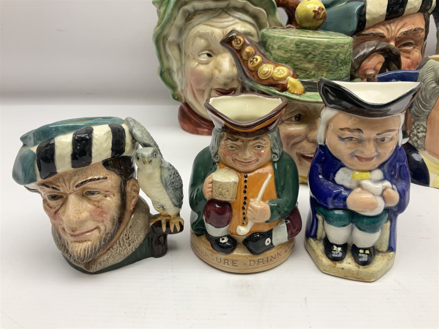 Collection of Royal Doulton and Beswick character jugs of various sizes, including North American Indian D6611, The Falconer D6533,  Tony Weller 281, Sairey Gamp 371 etc