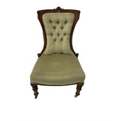 Victorian walnut nursing chair, the cresting rail carved with central floral motif, upholstered in buttoned fabric, turned supports on castors 