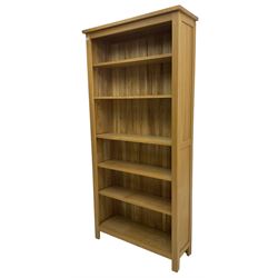 Contemporary light oak open bookcase, fitted with five adjustable shelves
