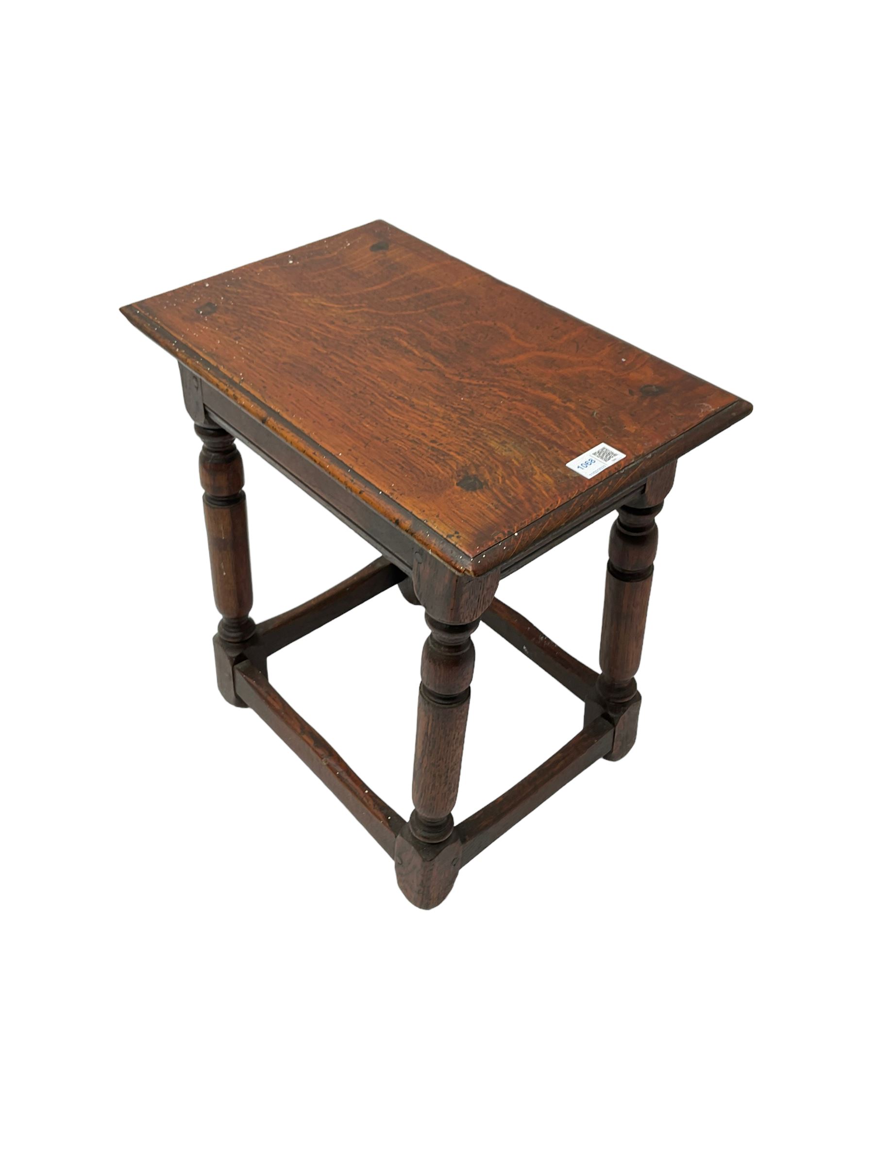 Oak coffin or joint stool, rectangular top with shaped edge over splayed turned supports with stretcher base 