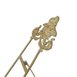 Three Baroque design brass table easels, the largest with cast mask detail, H47cm, and two matched graduated examples, smallest H25cm