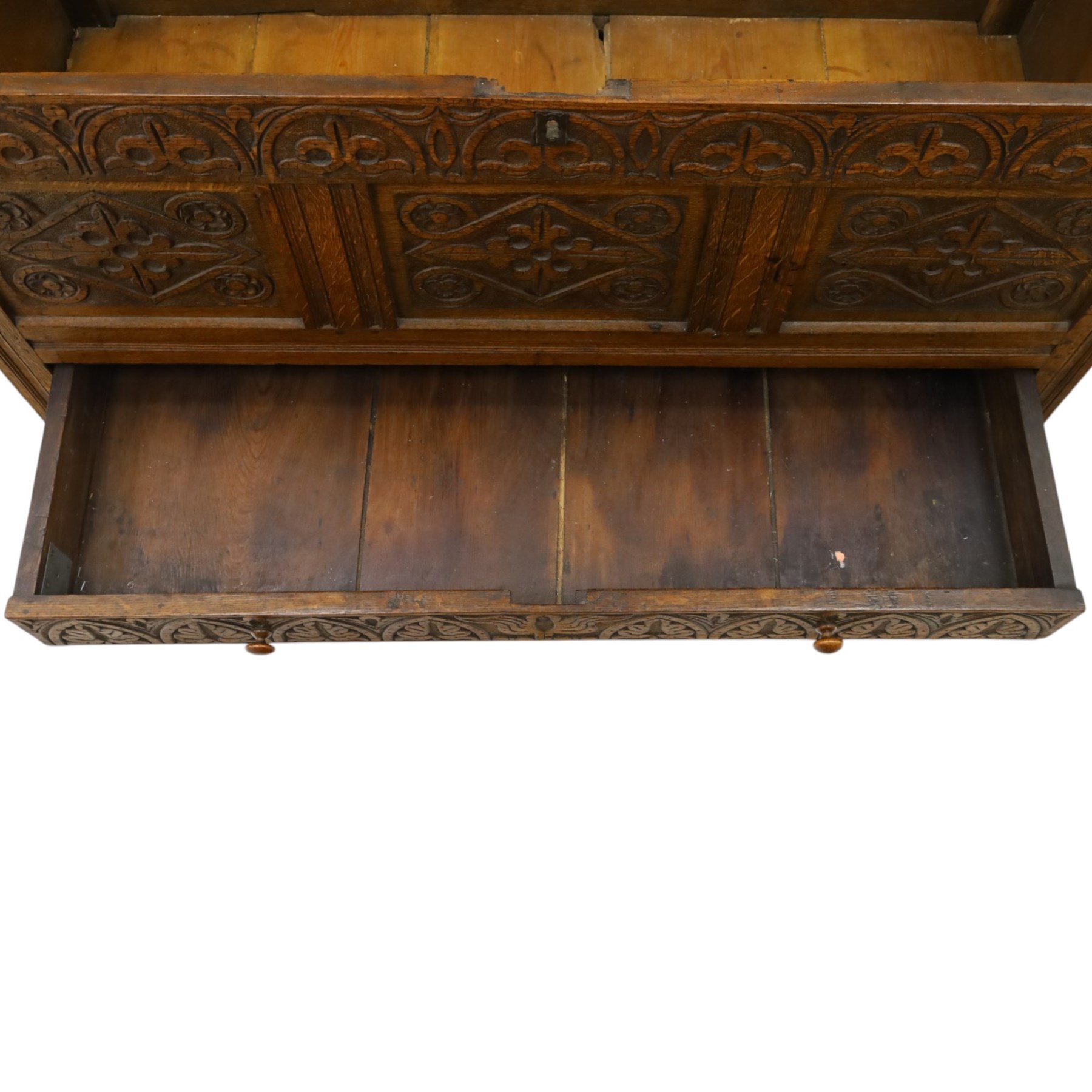18th century carved oak coffer, rectangular hinged top over a lunette-carved frieze and tracery-style carved triple panelled front, the lower rail carved with repeating anthemion motifs, on square feet