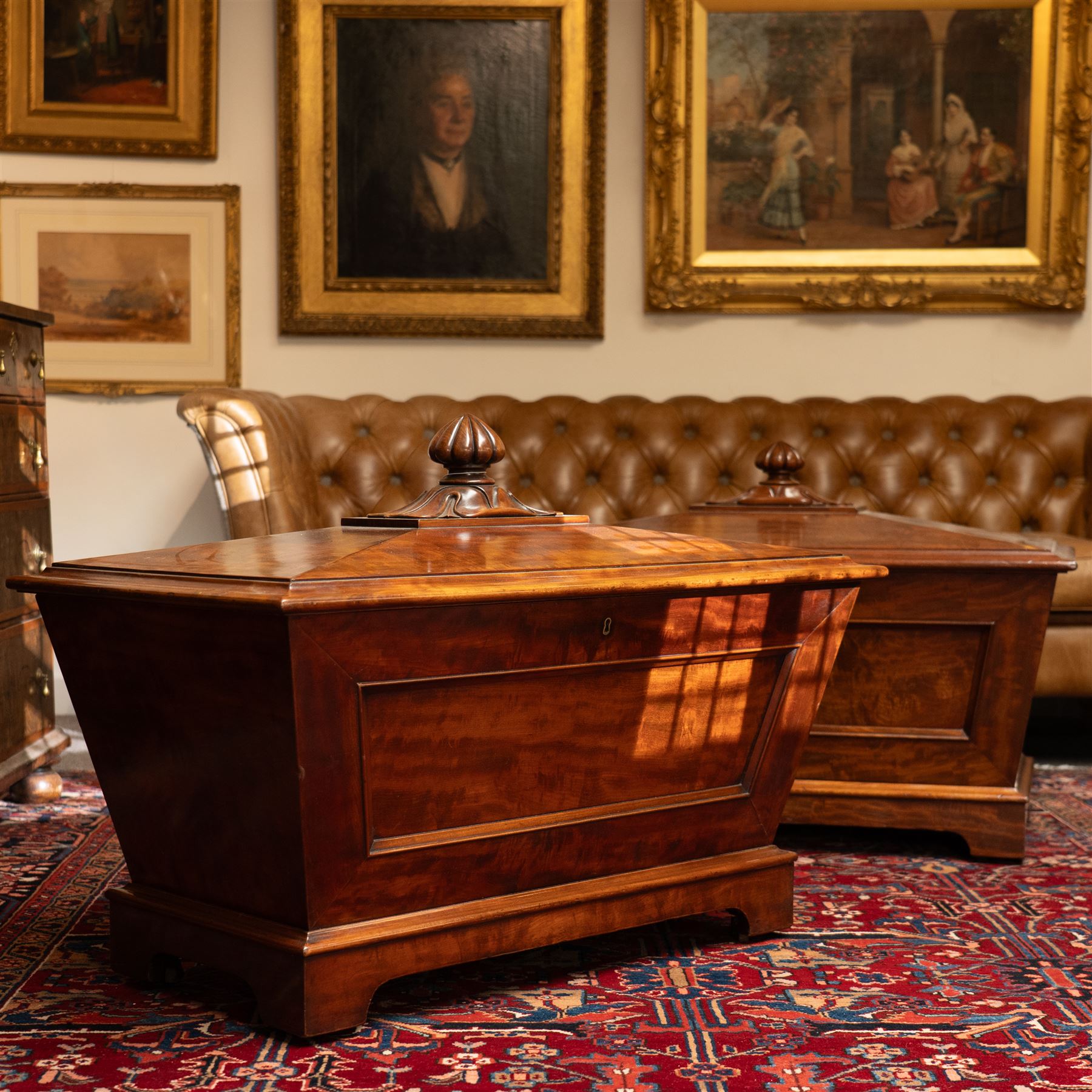 Thomas & George Seddon (1815-1870) - Pair of mid-19th mahogany cellarettes of sarcophagus form, the hinged and panelled top surmounted by a gadrooned and lappet carved knop, surrounded by a moulded edge, enclosing a lead lined wine cooler interior to one, the other paper lined, lower moulded edge over bracket feet and castors