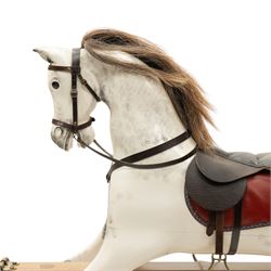 Late 20th century polychrome painted rocking horse, modelled in dapple grey finish with real hair mane and tail, leather tack and saddle, stirrups, raised on a natural wood safety trestle base