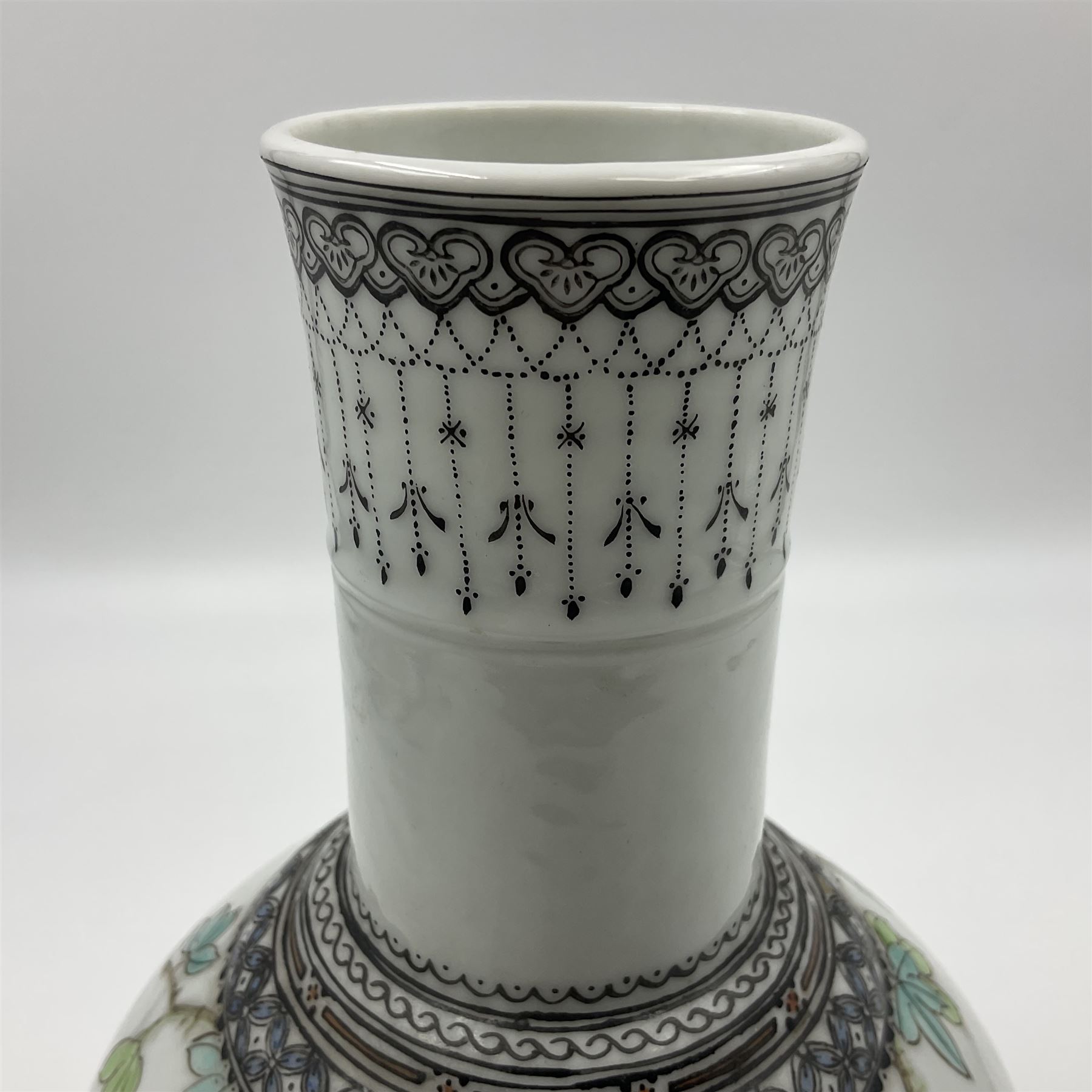 Pair of Chinese Republic porcelain vases, each painted in Famille Rose enamels with pairs of pigeons amidst peony, rock, flowering plants and leafy branches, possibly Qianlong seal beneath, H22cm 