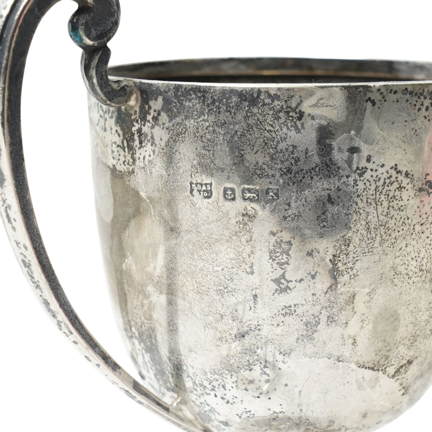 Silver trophy, small silver toast rack and a silver napkin ring