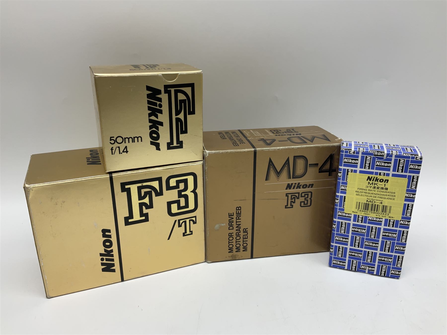 Nikon F3T camera body, in champagne/ titanium colourway, serial no. T8215031, with 'Nikon Nikkor 50mm 1:1.4' lens, Nikon MD4 motor drive, serial no. 156592 and Nikon MK-1 Firing range converter, all with original boxes 