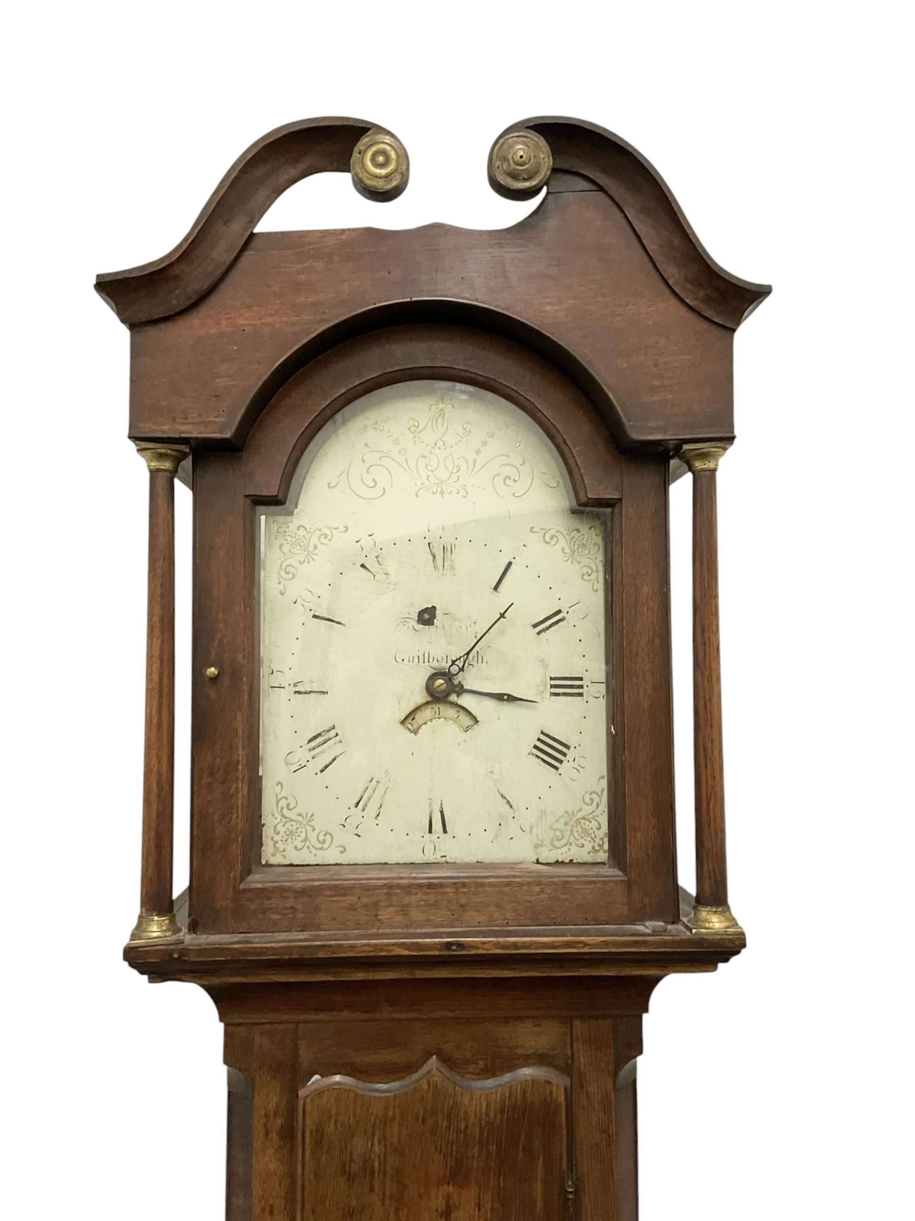 Early 19th century- 30hr oak longcase clock with a swan necked pediment and break arch hood door, trunk with canted corners and a long wavy topped door, on a rectangular plinth with applied skirting, painted dial with gold painted rococo spandrels to the corners and arch, Roman numerals and steel hands, makers name indistinct but retailed in Guisborough, with a rope driven countwheel striking movement, striking the hours on a bell. With weight and pendulum.