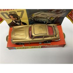 Corgi -  James Bond Aston Martin D.B.5 from the Film 'Goldfinger' No.261, with gold body, ejector seat, James Bond and bandit figures, rear bullet screen, retractable machine guns, secret instructions in opened envelope, two spare bandit figures with lapel badge stuck to back of diorama, which has plain orange base; boxed