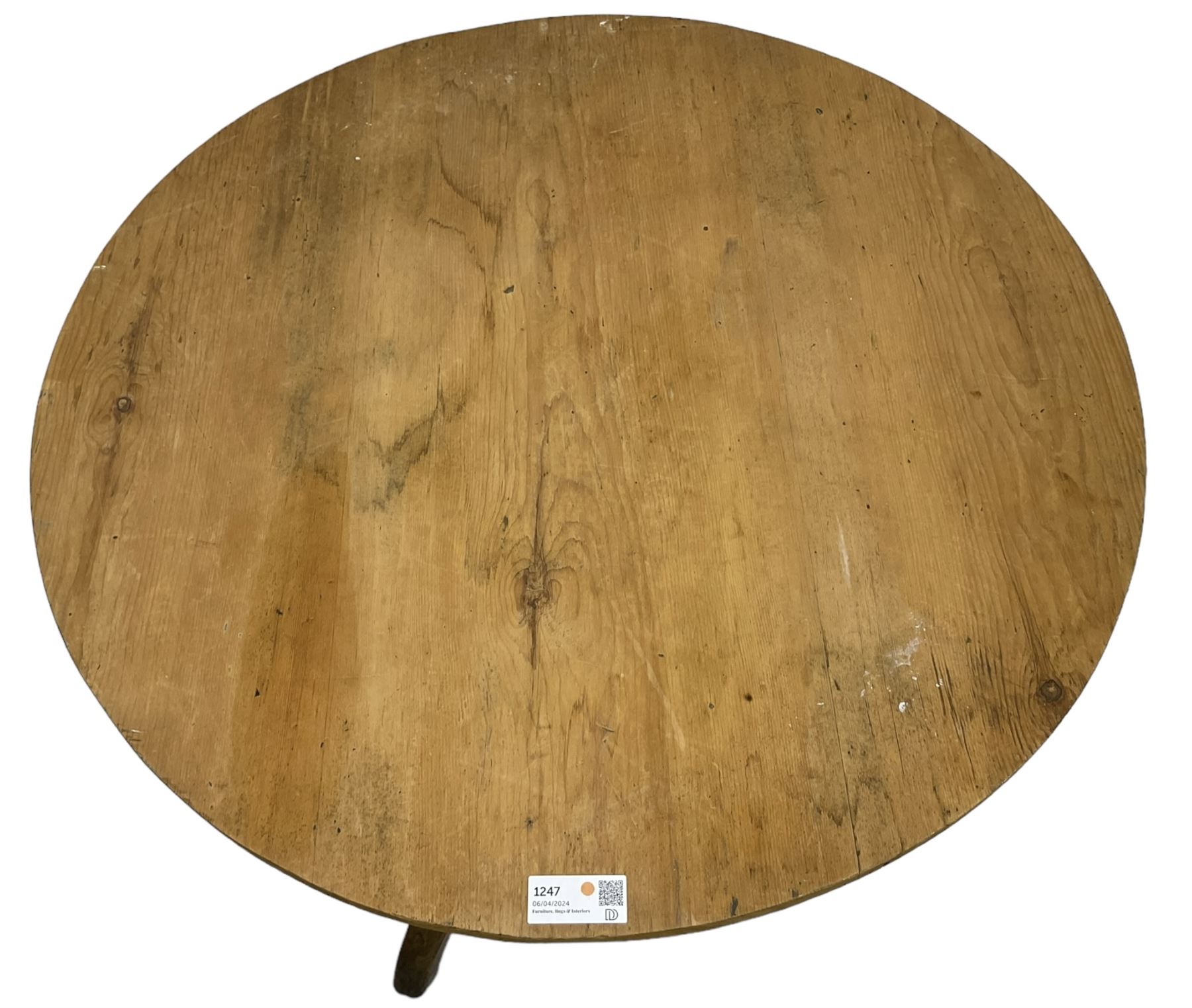 Early 19th century pine and elm tripod table; circular tilt-top over turned column and three splayed supports