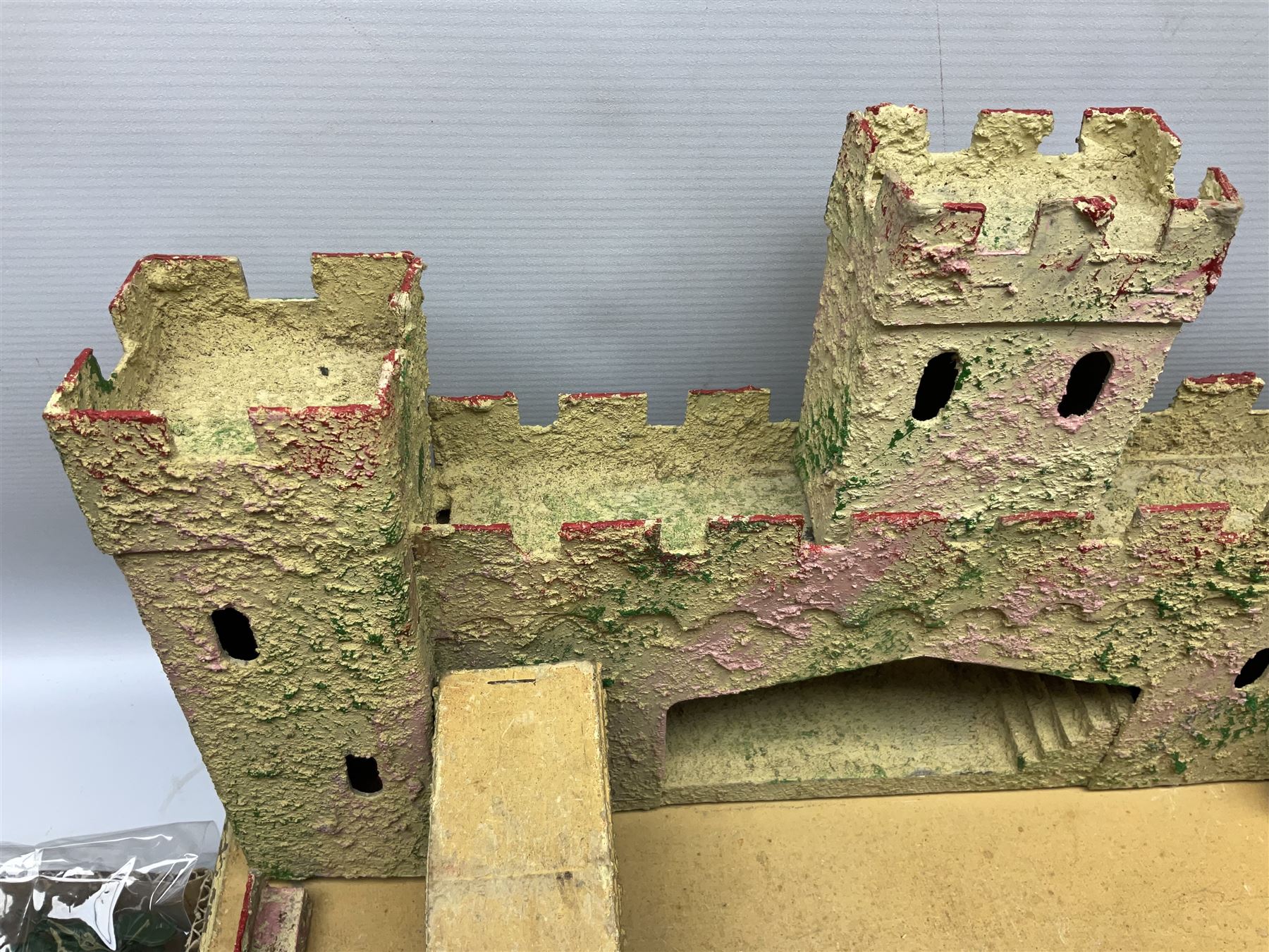 Sectional wooden fort on base with painted textured finish 46 x 36cm; together with over thirty lead and die-cast white metal soldiers and horses by various makers; and a small quantity of plastic figures of soldiers