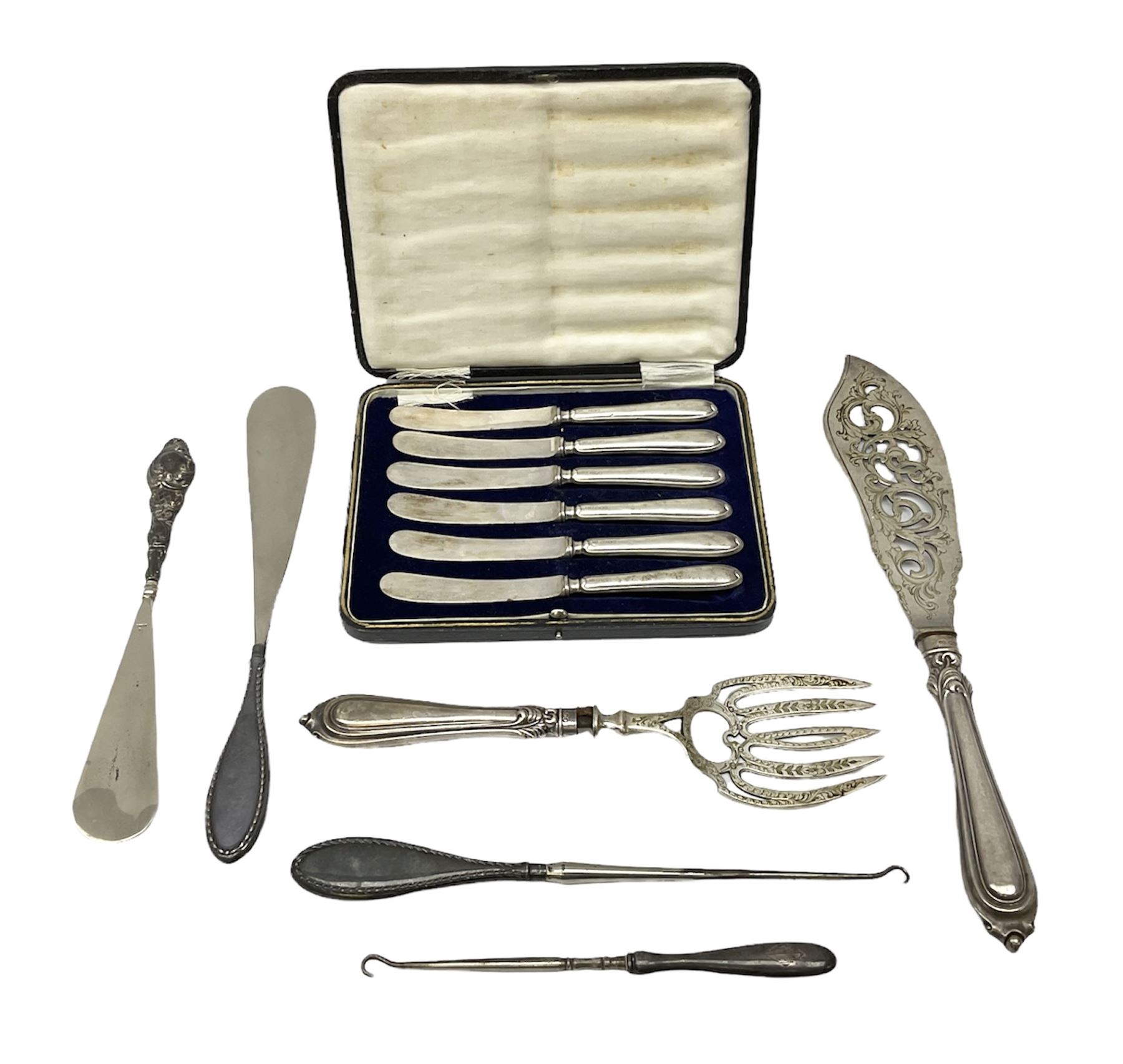 Set of six silver handled butter knives, in case, pair of silver handled fish servers, two silver handled shoe horns, and two silver handled button hooks, all hallmarked or stamped Sterling