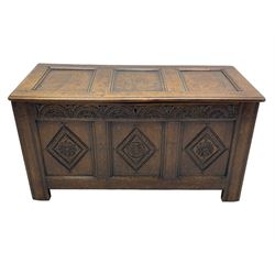 18th century oak coffer or chest, rectangular triple panelled hinged top with moulded edge enclosing main compartment and candle box, the frieze carved with repeating concentric lunettes and foliate patterns, the front fielded panels decorated with lozenges containing central flower heads, on stile supports