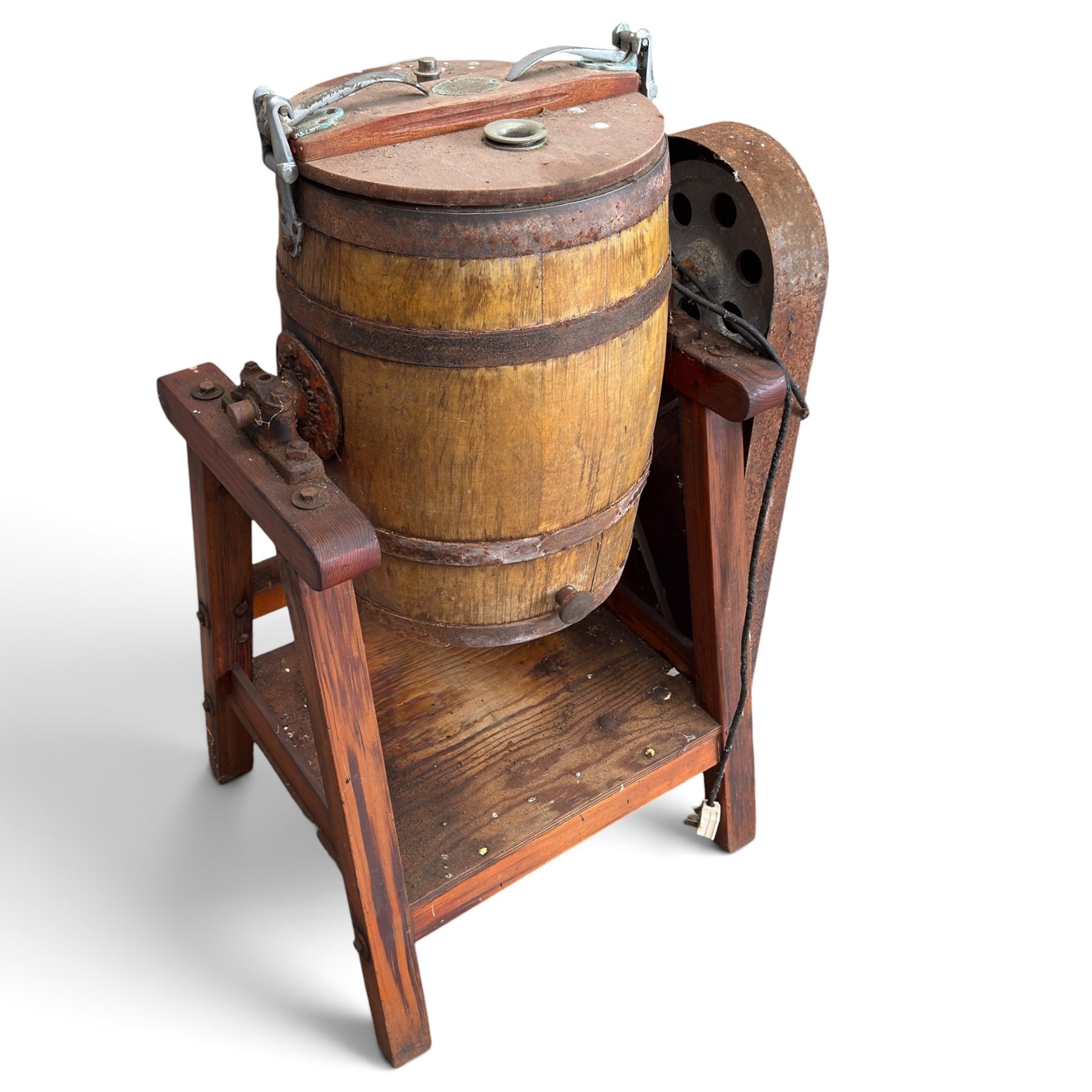 Two early 20th century dairy equipment items: Waide & Sons, Leeds – oak barrel butter churn with iron bands, later converted to electric operation, on trestle stand (W71cm H115cm); Lister – ‘Ball Bearing’ cast iron cream separator, with hopper and foot pedal, in red-painted finish (W47cm H49cm)