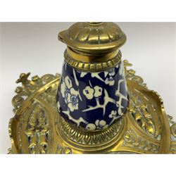 Victorian desk set, comprising an ink stand of square form with pierced and moulded decoration, inset with blue and white ceramic inkwell decorated with blossoming branches, together with a matching pair of brass mounted candlesticks, inkwell W15cm L15cm H13cm