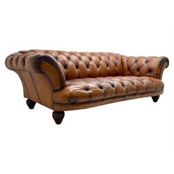 Tetrad - 'Oskar' grande three-seat sofa, Chesterfield shape with rolled arms, upholstered in buttoned tan leather, on turned and reed moulded feet 