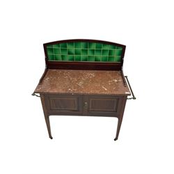 Edwardian inlaid mahogany washstand, raised back with emerald green tiles over marble top, fitted with two panelled cupboard doors, raised on square tapering supports on ceramic castors