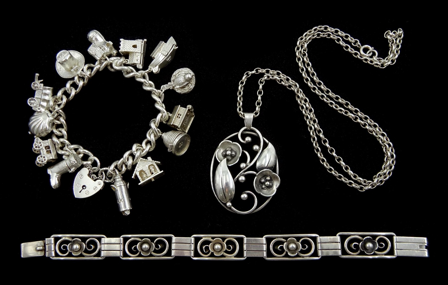 Silver charm bracelet, charms including bee in hive, terrier dog in boot, milk churn, gypsy caravan, Conestoga wagon, bird laying on nest and Noah’s ark, Swedish silver floral pendant, on silver chain and silver rose flower bracelet