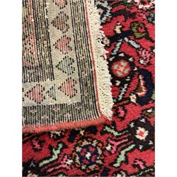 Persian red ground runner, decorated with large Herati motifs and shaped central medallion, the guarded border decorated with repeating heart motifs