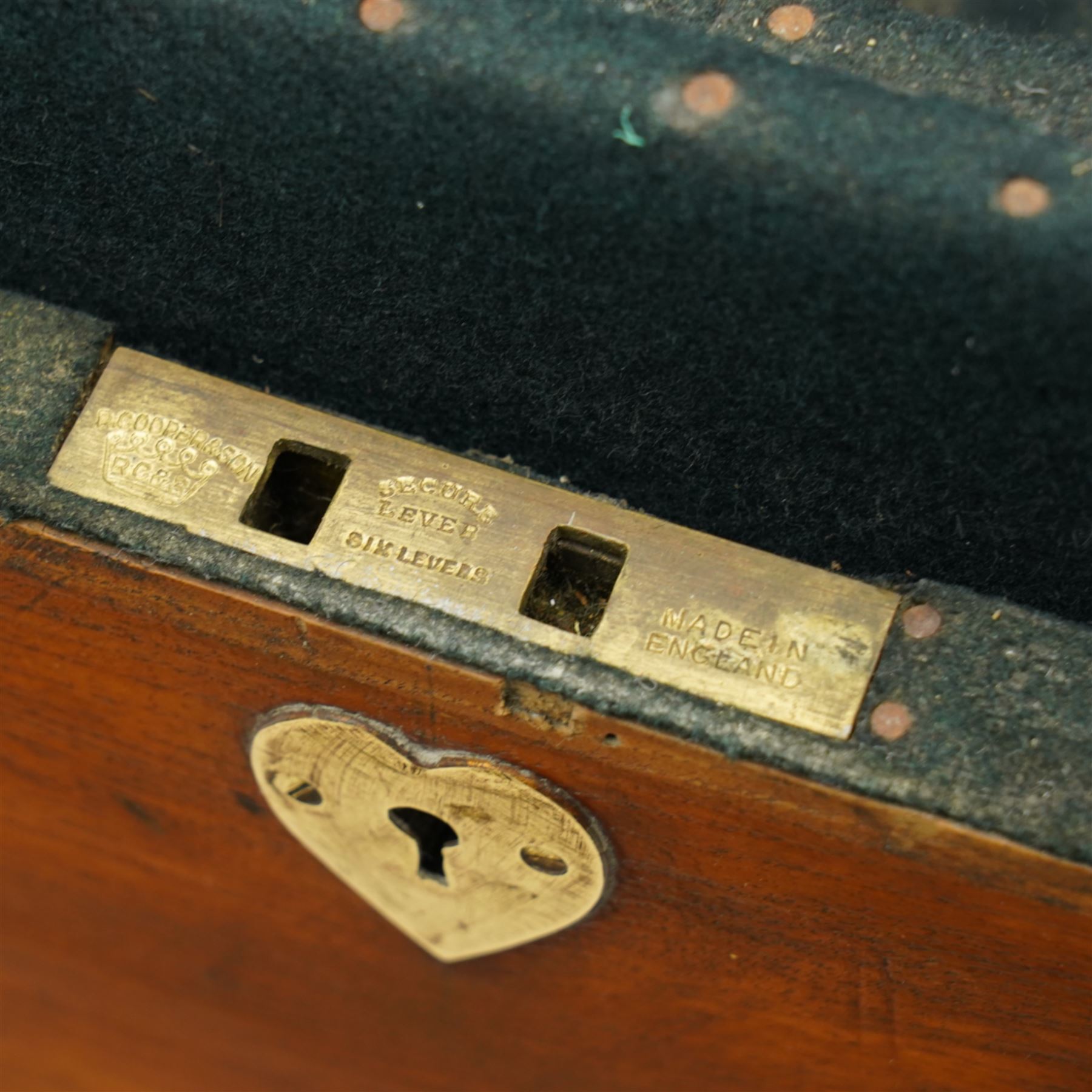 Early 19th century teak and brass bound silver campaign chest, fitted with brass L-shaped brackets and heavy weight carrying handles, the hinged lid enclosing two removeable trays with divisions and lined in blue baize, fitted with two 'R. Cooper & Son' brass locks