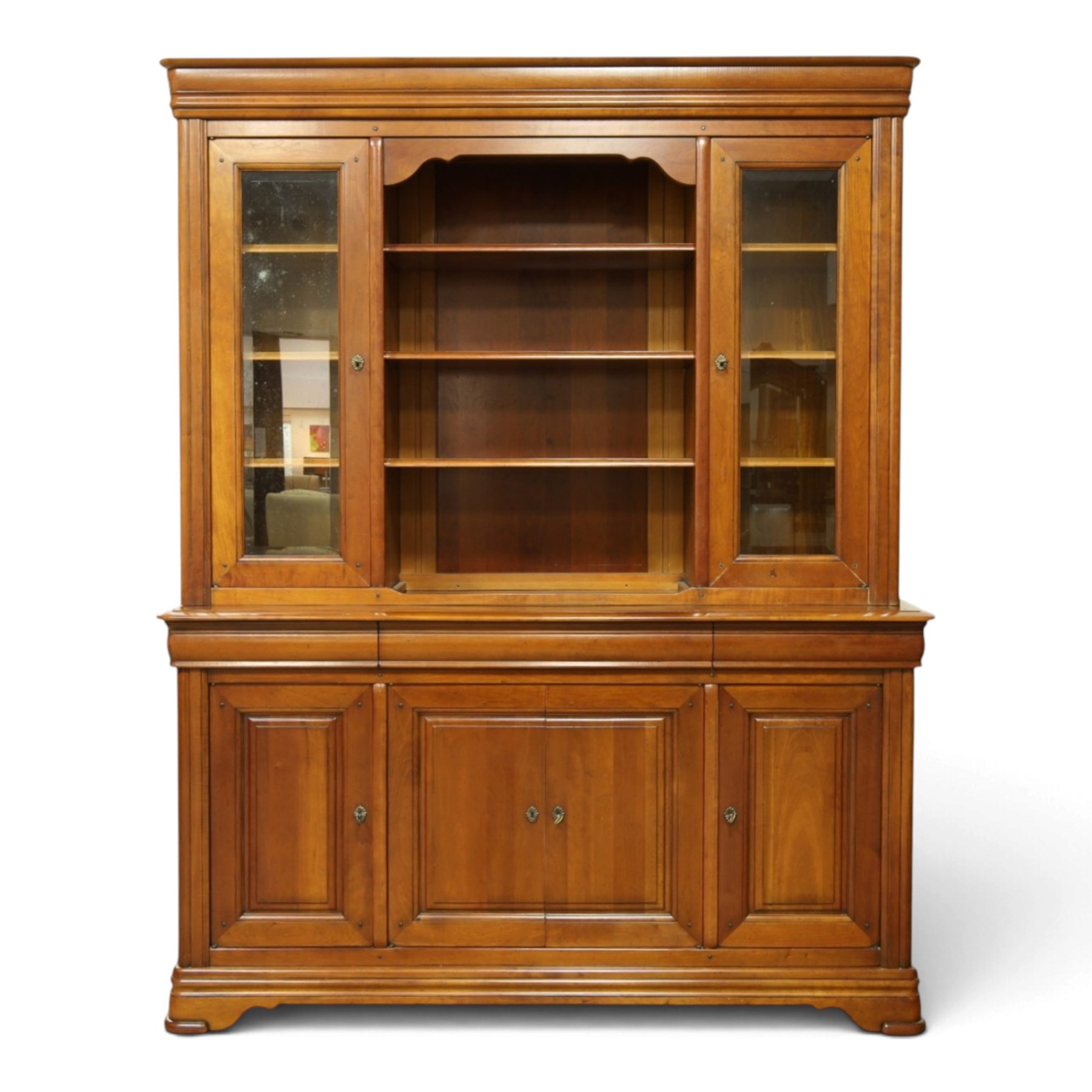 Barker & Stonehouse - large cherrywood bookcase cabinet, the moulded cornice above two glazed doors flanking an open central section, the base with three cushion drawers over four lockable panelled cupboard doors, raised on bracket feet