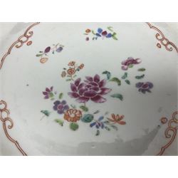 Three 18th century Chinese Famille Rose plates, the first example enamelled with blossoming peonies, rockwork and fence, the other two examples of similar design, decorated with blossoming peonies and sprigs within shaped inner borders, each approximately D23cm