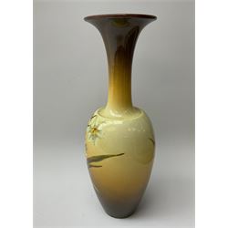 A Doulton Lambeth vase, of baluster form with flared rim, decorated with daffodils, with printed, impressed and painted marks beneath, H30cm.