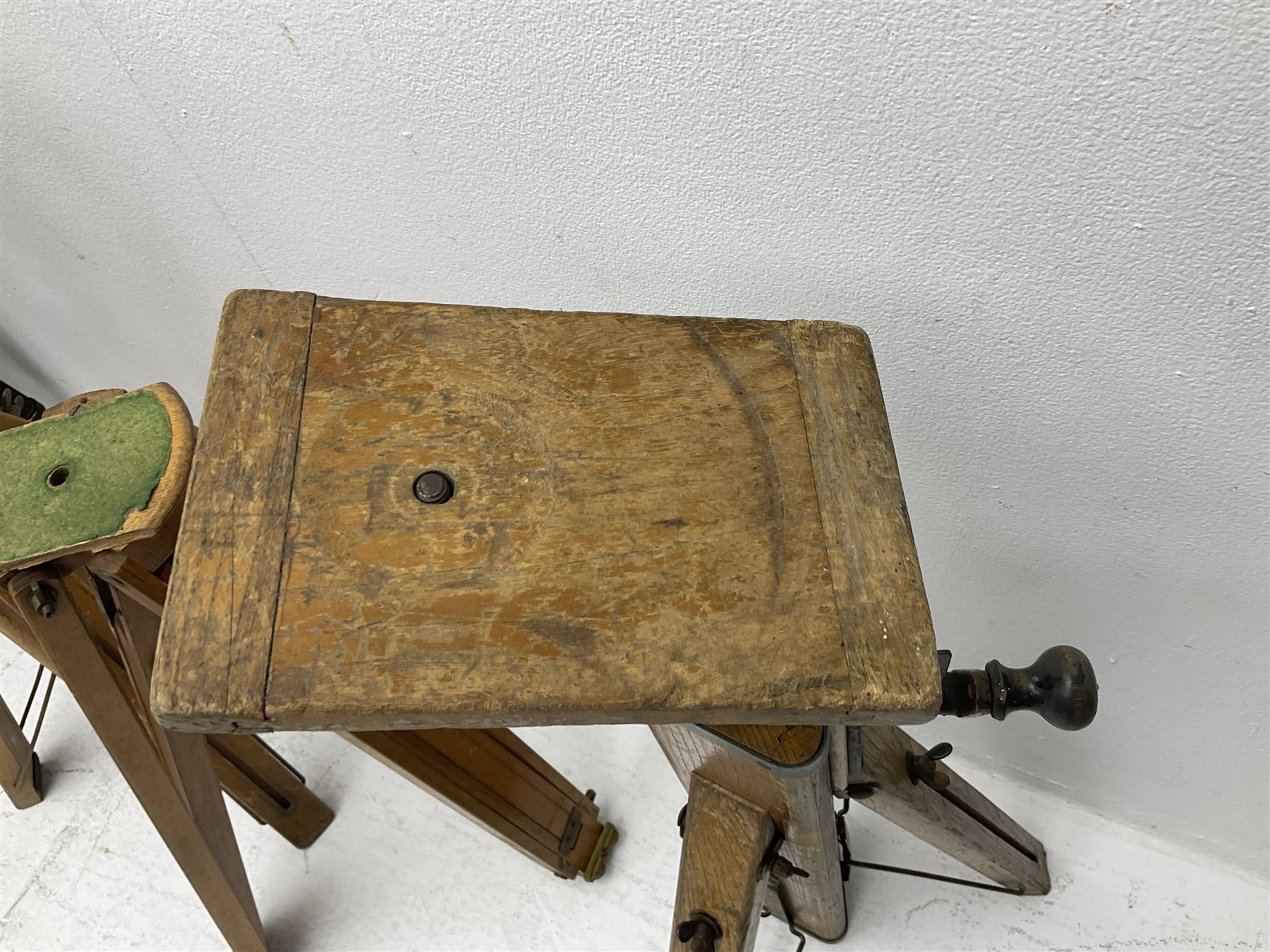 Three wooden adjustable tripods for plate cameras, together with a Linhof of Munchen metal tripod in a canvas case 