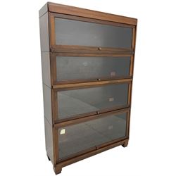 Globe Wernicke - early 20th century mahogany four-sectional stacking library bookcase, each shelf enclosed by glazed up-and-over doors, raised on square block feet