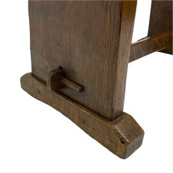 Yorkshire Oak - adzed oak plank stool with leather seat pad, splayed end supports on sledge feet joined by pegged stretcher 