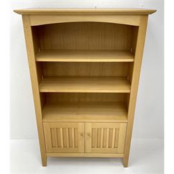 Light oak open bookcase, two shelves above two cupboard doors, stile supports