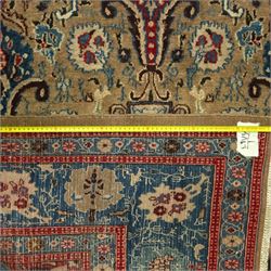 Central-Western Persian Sarouk hand-knotted carpet, beige ground, with an all-over design of boteh and floral sprays in red and blue within a floral border on blue ground 