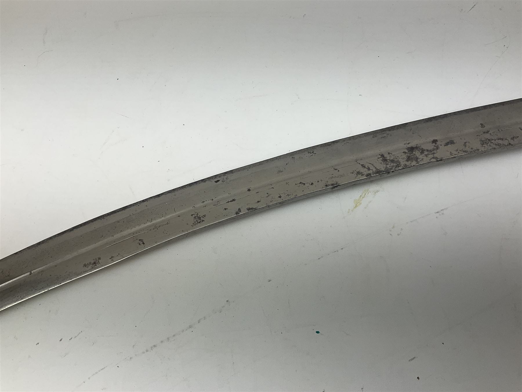 19th Century Indian Tulwar sword with 77cm single edged, slightly curved fullered blade;  steel crossguard, langets, grip and spiked disc pommel with stiff leaf decoration L90cm overall