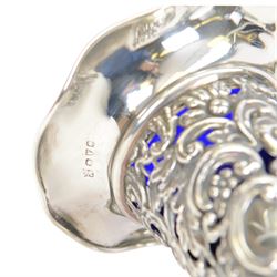 Two late Victorian silver mounted vases, including blue glass mounted example with fluted rim and upon circular foot, hallmarked Henry Matthews, Chester 1900 and a tapering example with fluted rim and pierced embossed scroll decoration to body, with blue glass liner, hallmarked James Deakin & Sons, Chester 1897, tallest H18.5cm