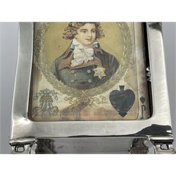 Edwardian silver mounted playing card case, hallmarked William Harrison Walter, Birmingham 1903, the sides each with a period playing card set behind a bevelled glass panel, the hinged cover with later engraving 'Presented to Norman T Crombie Esq by the officers & men of the 31st WR Detachment for services rendered 1917-1918', with red leather lined interior, the three compartments upon a sprung base and containing two later wooden Whist markers, case H12.5cm