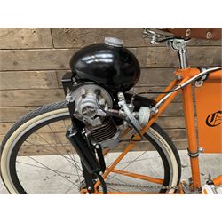Fully restored vintage advertising bicycle with 2 stroke petrol engine, orange frame, tan leather seat