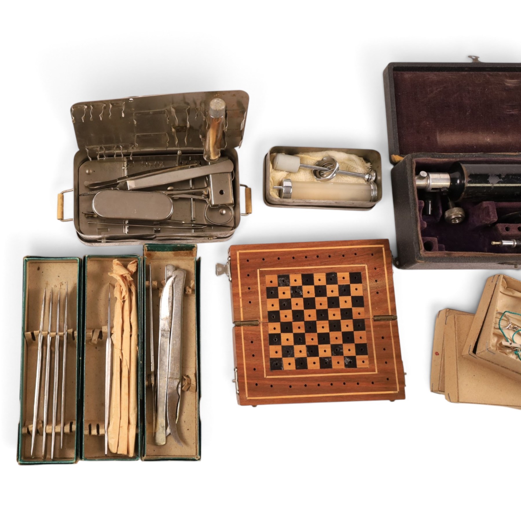 Field medical equipment, including scalpels, syringe, small weights and scales, ophthalmoscope, etc, contained within a steel uniform case