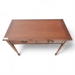 Edwardian design mahogany desk, crossbanded rectangular top above twin drawers with brass handles, raised on square tapering legs terminating in spade feet