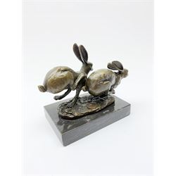 Bronze figure group, modelled as two hares in chase, upon a naturalistic base signed Nick and with foundry mark, raised upon a rectangular marble base, overall H12cm