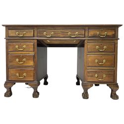 Early 20th century mahogany twin pedestal desk, fitted with nine drawers, on ball and claw carved cabriole feet