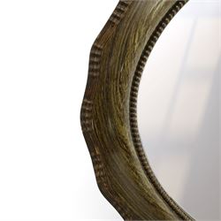 Oval wall mirror, shaped frame with bevelled plate 