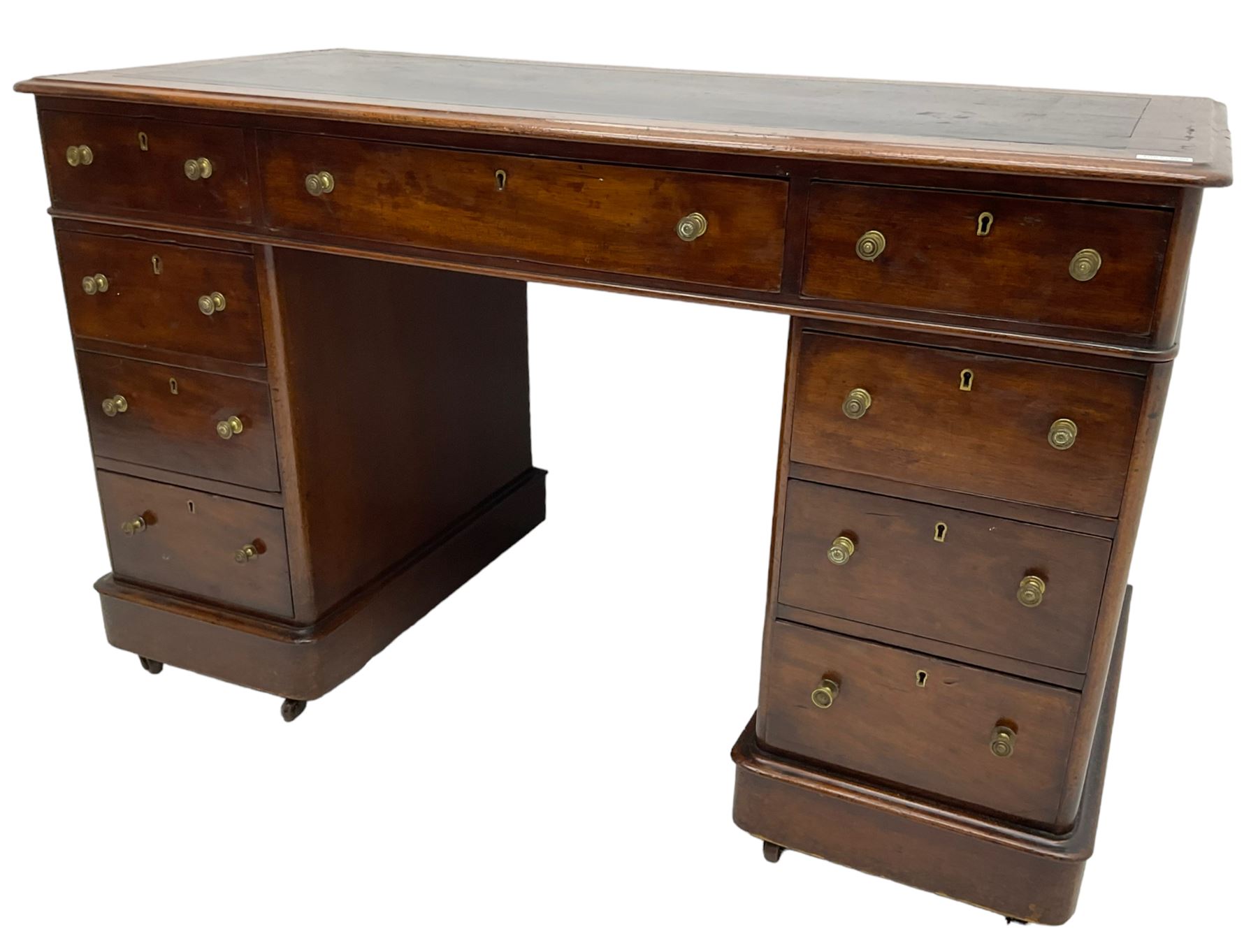 Victorian mahogany twin pedestal desk, rectangular top with inset ebonised leather writing surface, fitted with nine graduating drawers with brass pull handles, on plinth bases