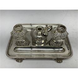 Silver plated desk stand and chamberstick, with two glass inkwells, each with hallmarked silver collars and five silver plated napkin rings